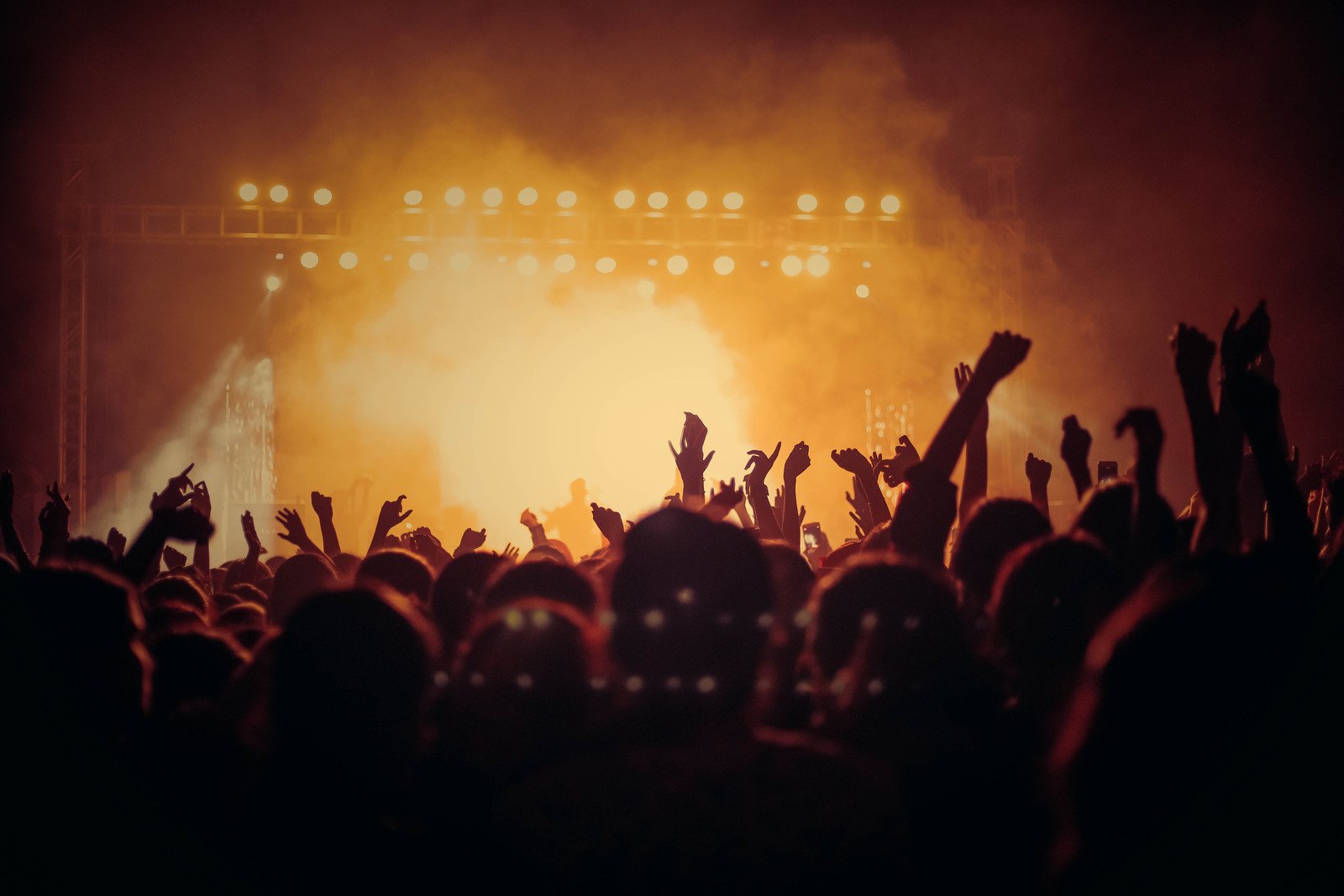 Concert audience with hands raised