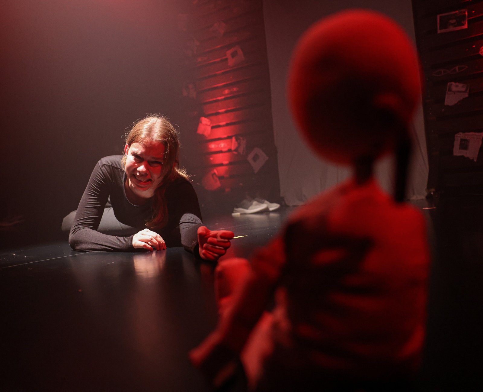 A performer seen from behind with another person across a table