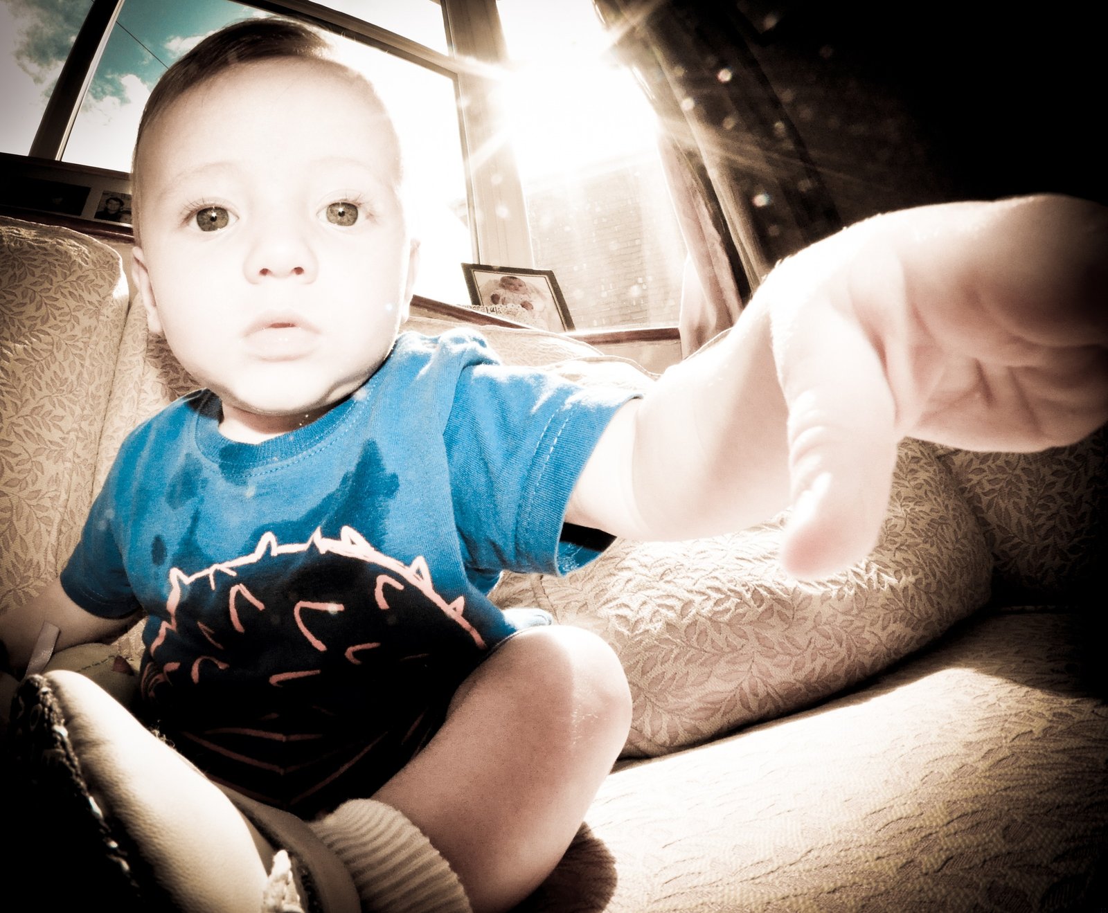 Child reaching toward a camera