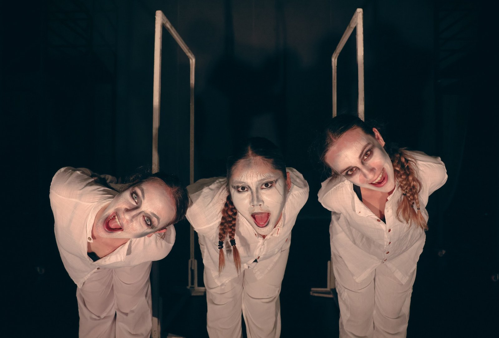 Three performers looking up at the camera